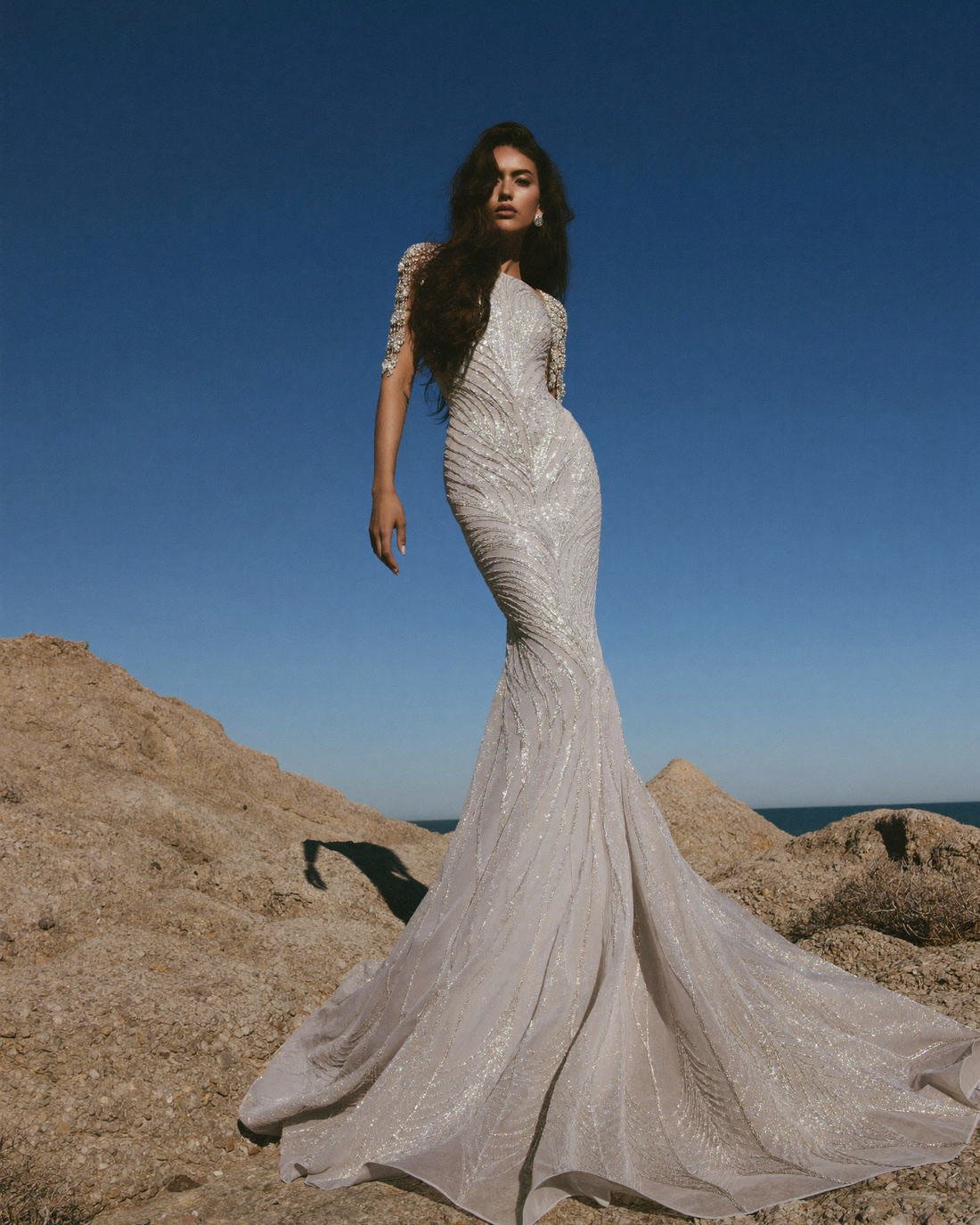 Embellished bridal gown on a rocky coastline, The Atelier Muse