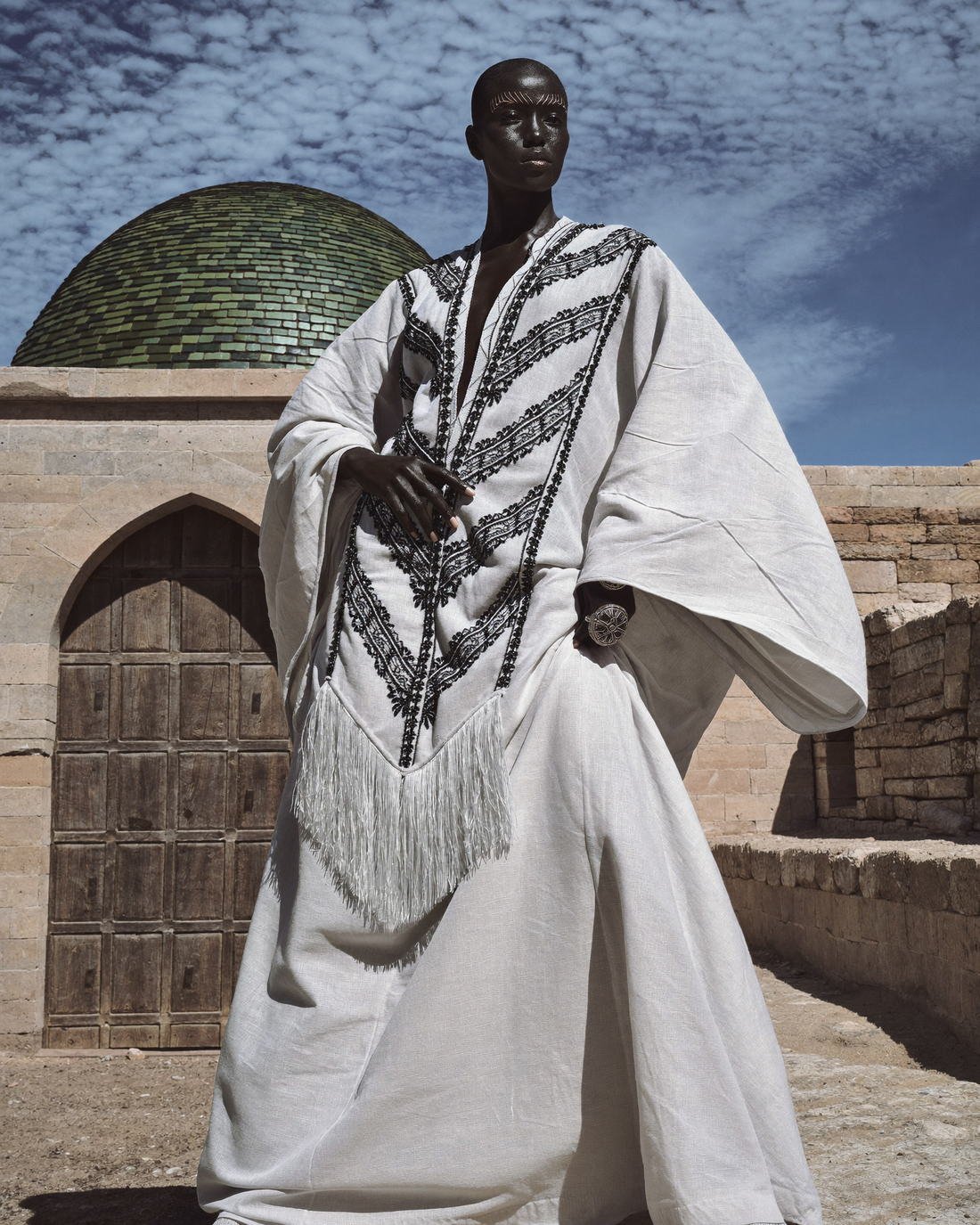 Embroidered robe at a domed doorway, Daughter of the Wind