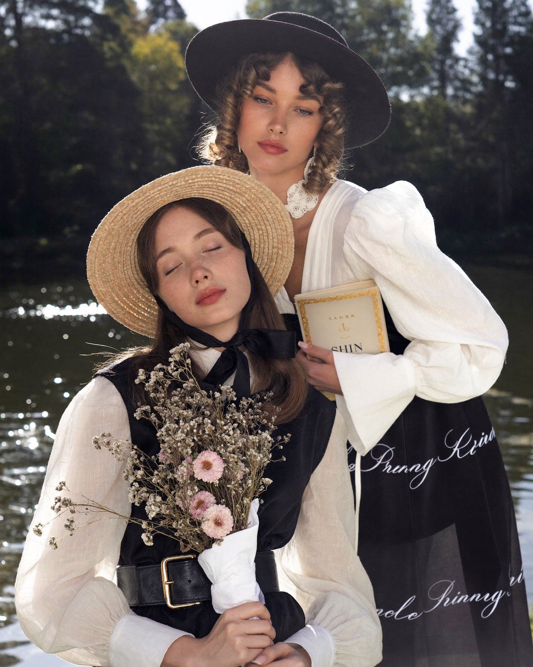 Two models in romantic tailoring by the water, Vestiges