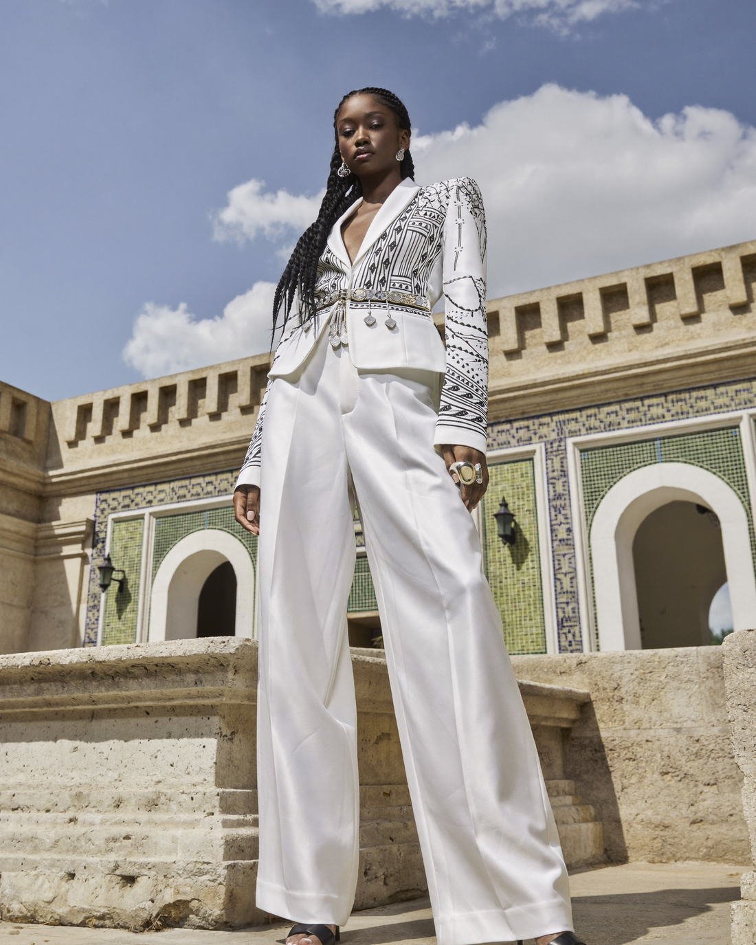 White tailored suit at ornate architecture, Daughter of the Wind