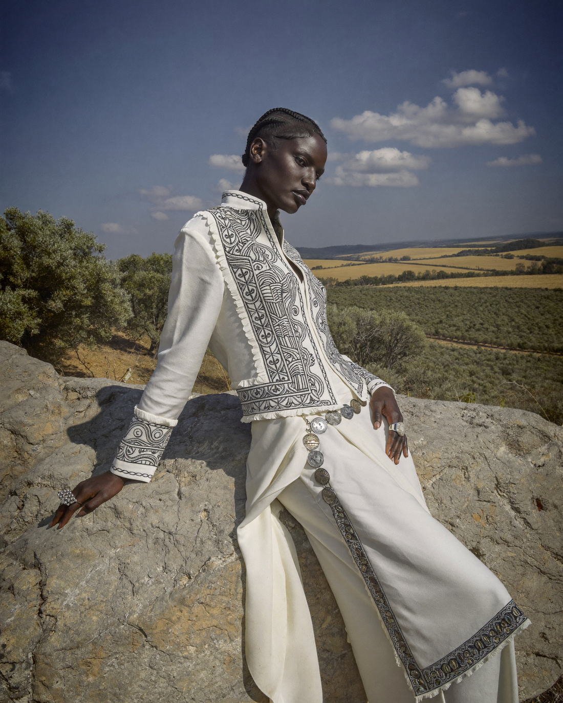 Embellished white couture jacket in open desert, Daughter of the Wind