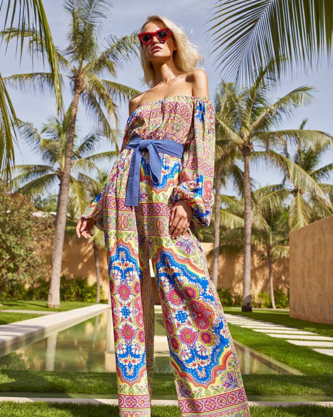 Printed bandeau top and wide-leg trousers among palms, Leaf Me Here