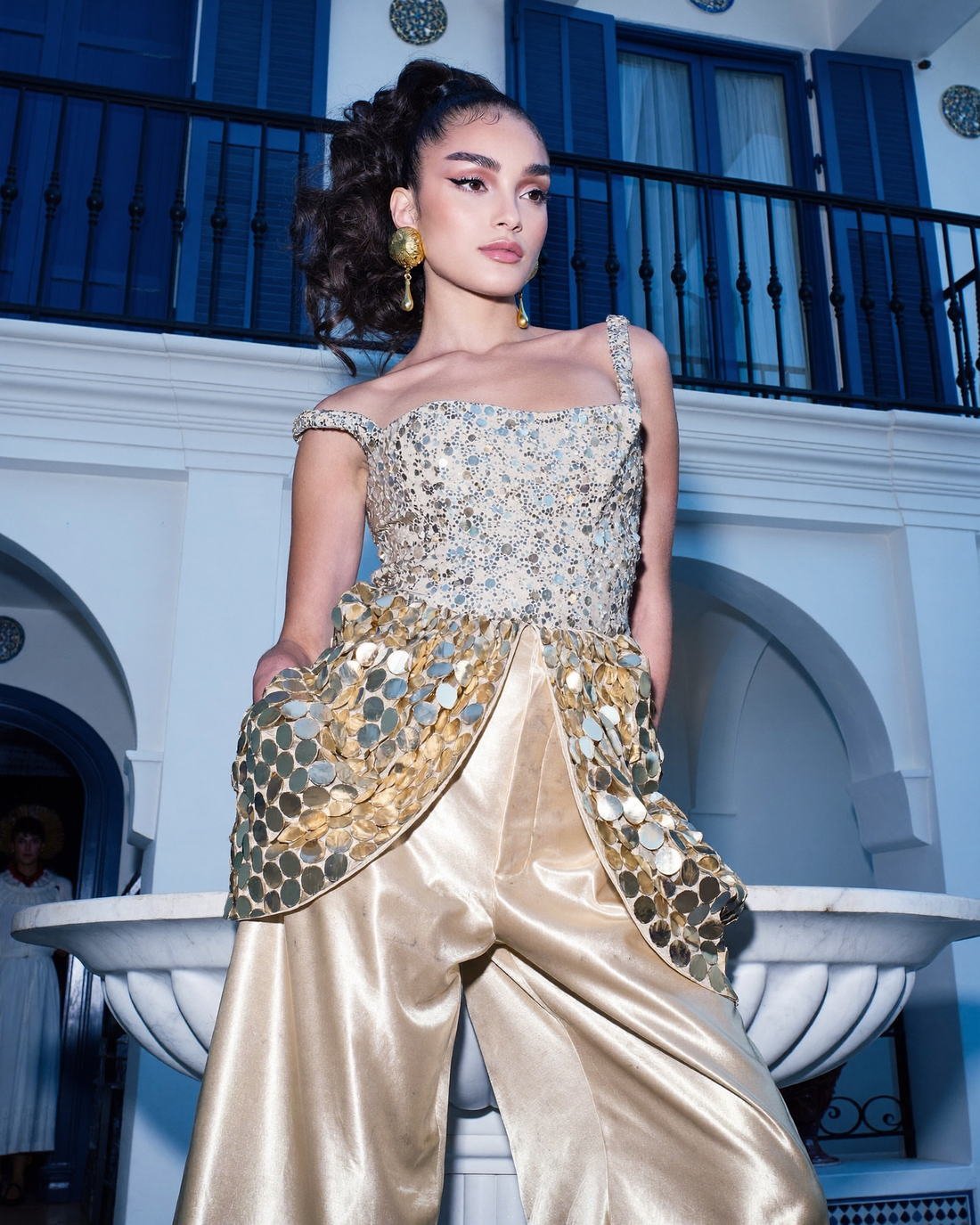 Embellished gold top and satin trousers by a tiled fountain, Past Perfect