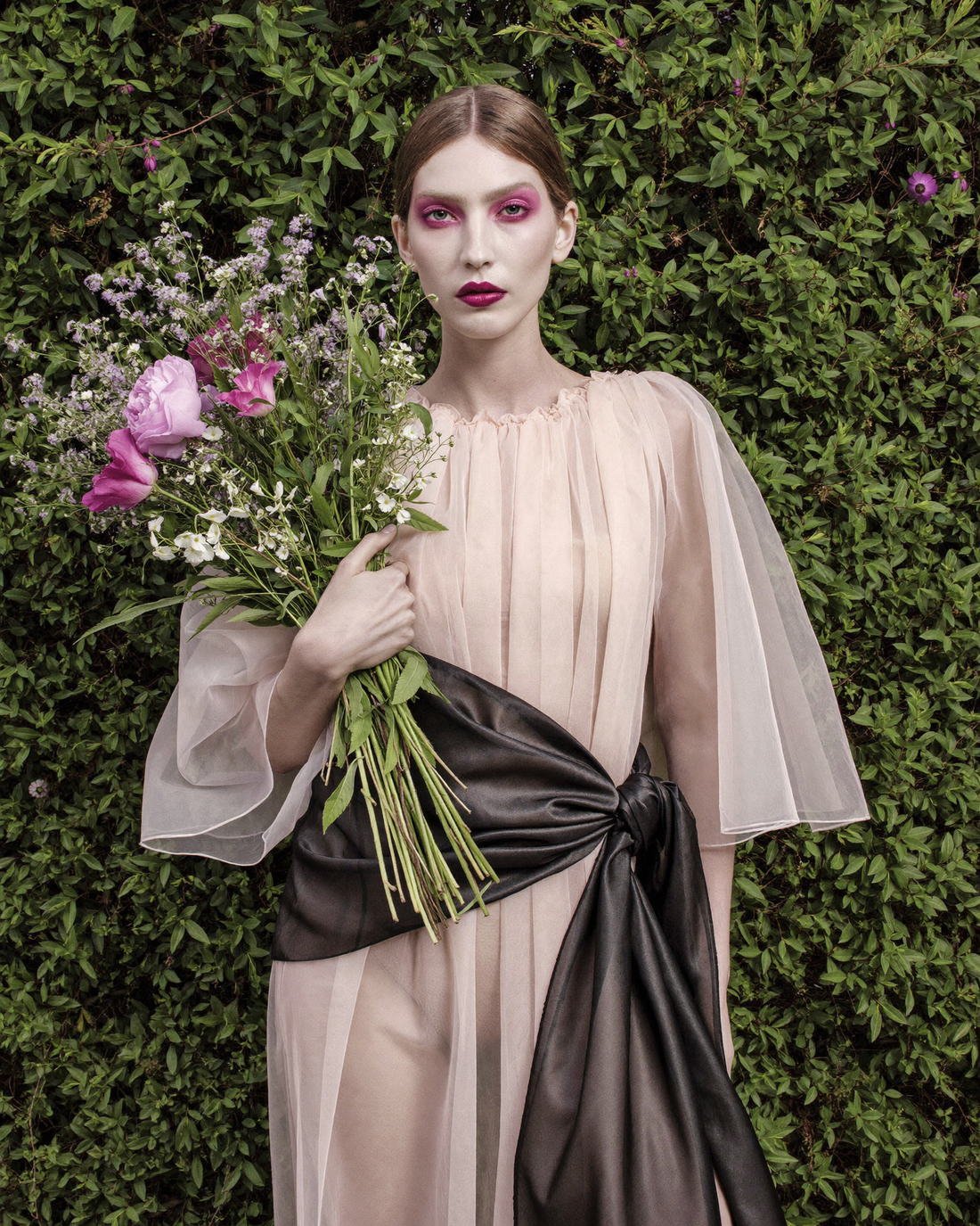 Blush organza gown with sash in a garden, The Artifact Edit