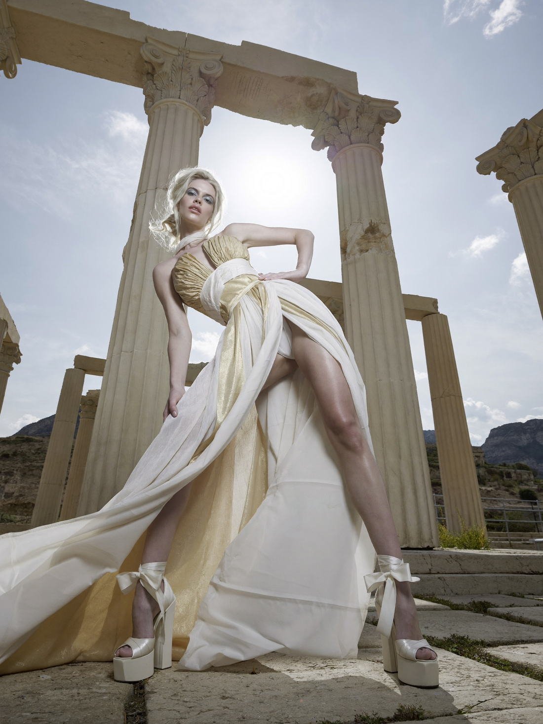 White gown against temple columns and open sky, Fragments of a Forgotten Queen