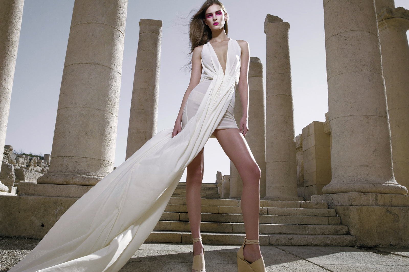Bridal couture with a sweeping train on the coast — photography by Ghassen Oueslati