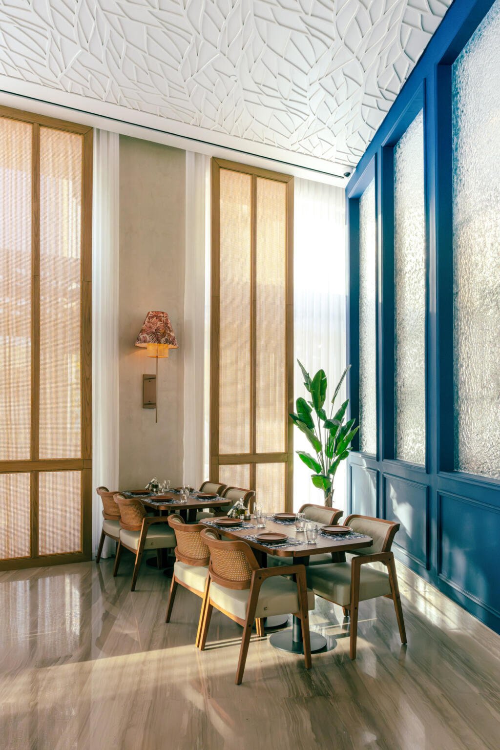 Window table at Loris with carved panels and a blue painted frame