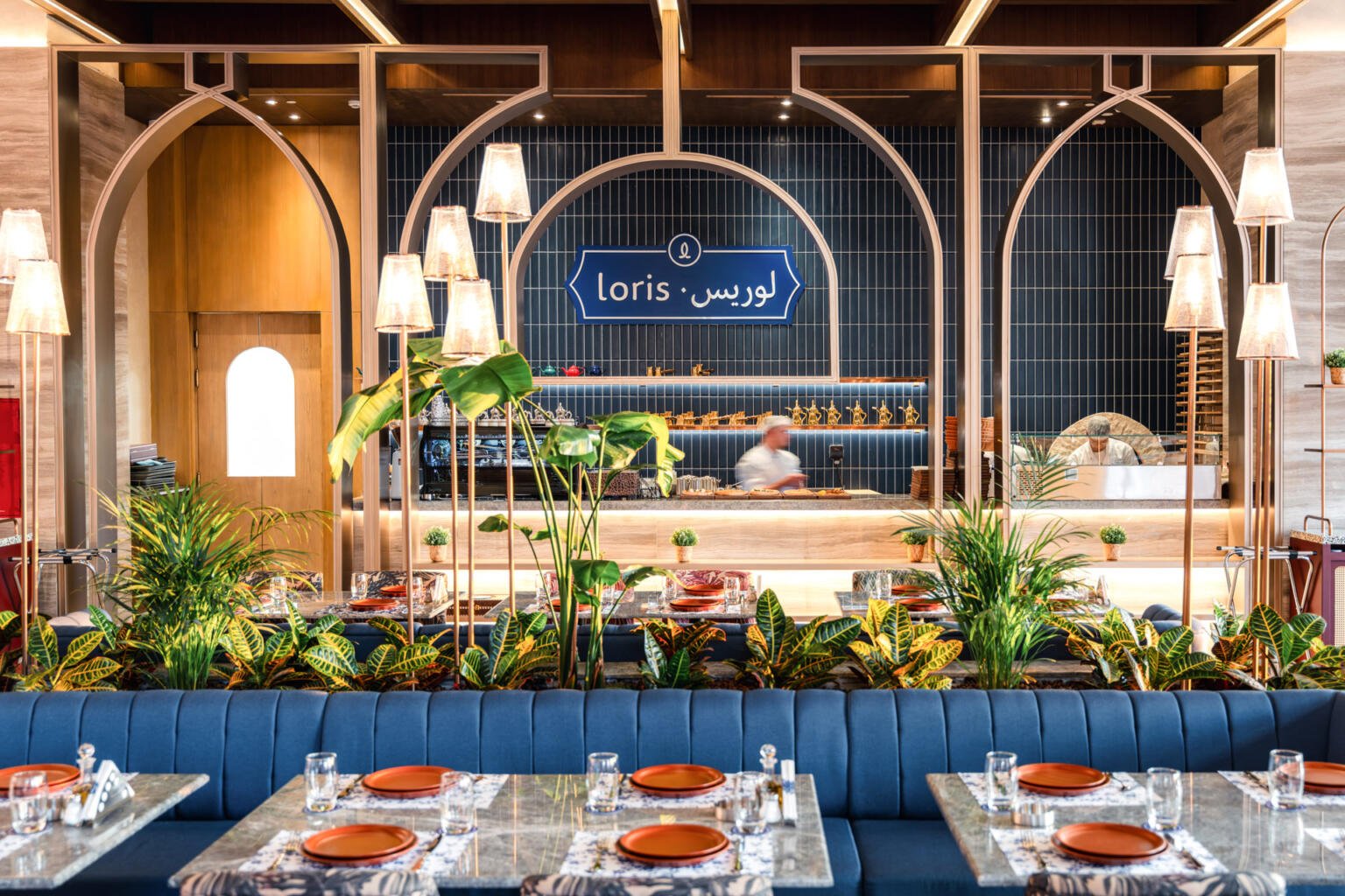 Terrace lounge chairs at Loris restaurant with the sea beyond