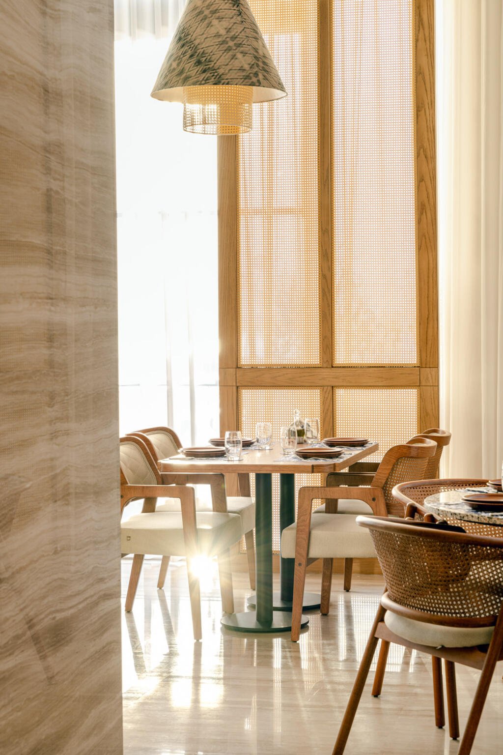 A table for two by the window at Loris with a printed lantern above
