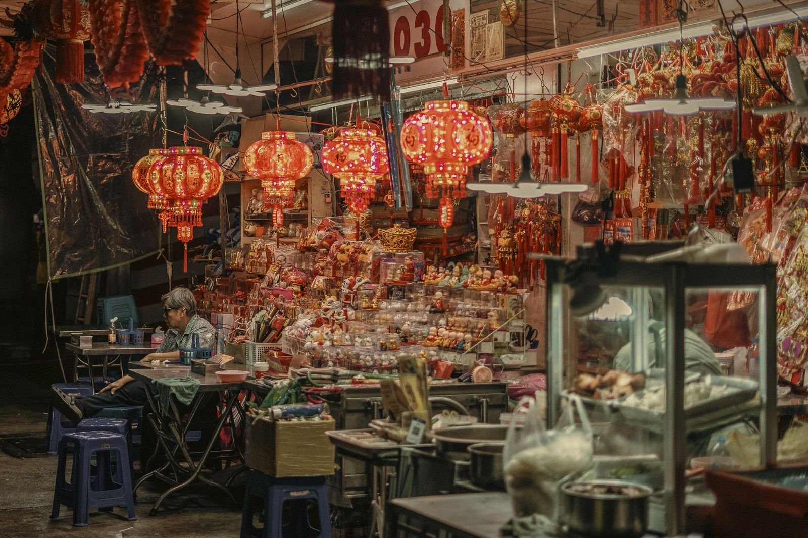 Red lanterns over a Chinatown market stall in Bangkok