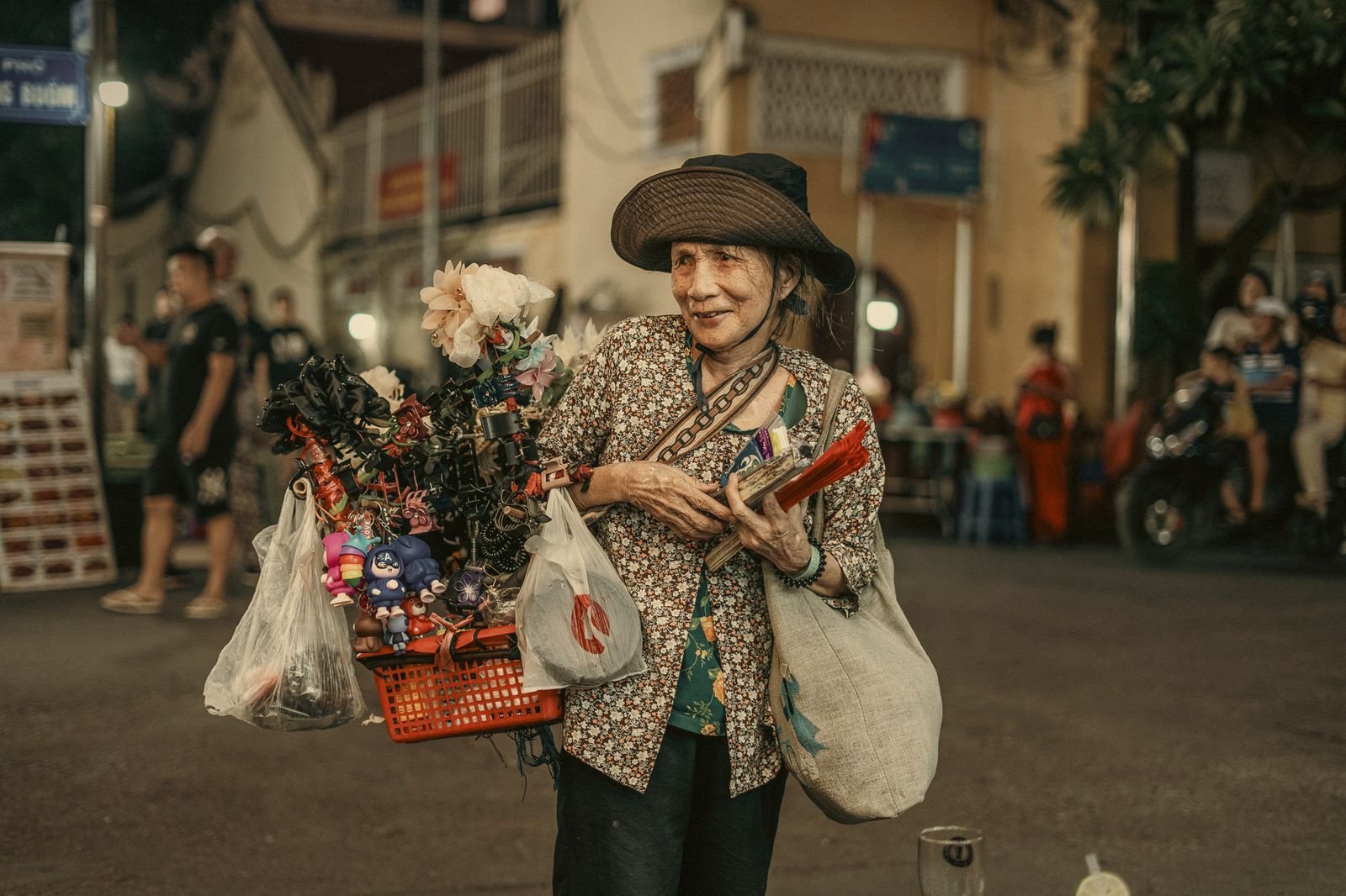 A street vendor smiling in the Hanoi Old Quarter, Vietnam