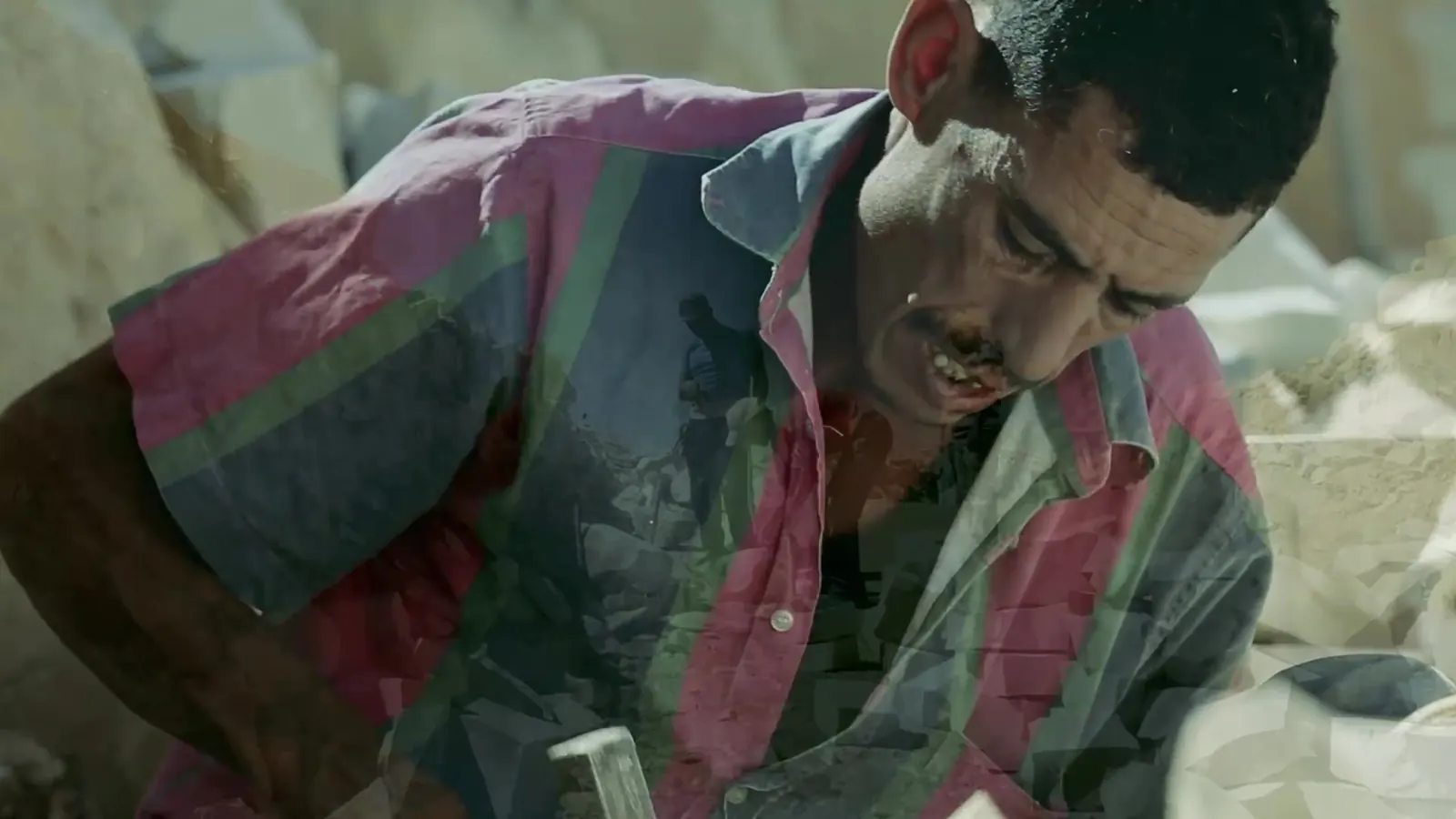 Stone worker shaping a block by hand, still from the ILO documentary films in Tunisia