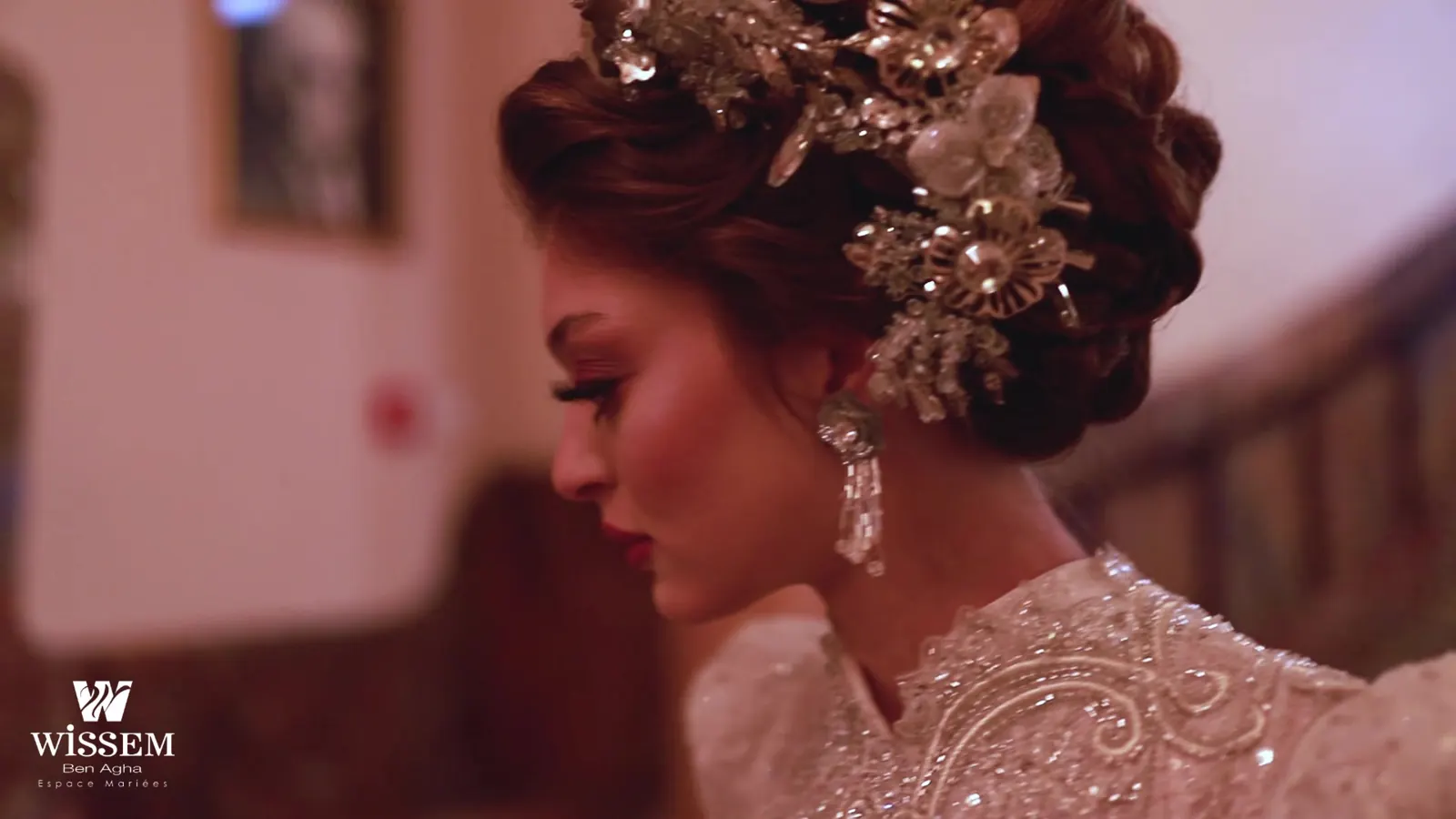 Close profile of a bride with a silver floral hair ornament and drop earrings