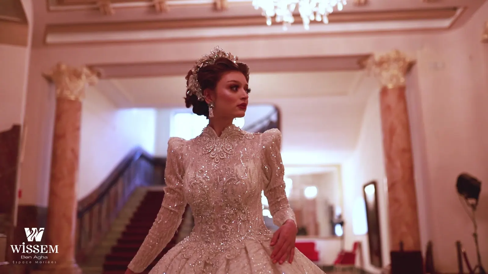 Bride standing in a marble hall with columns and a chandelier, opening frame of the In a Dream film