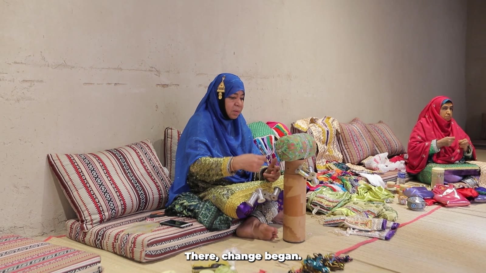 Two women working with textiles on floor cushions, opening still from the IPPF Arab World Regional Office impact film Investing in people