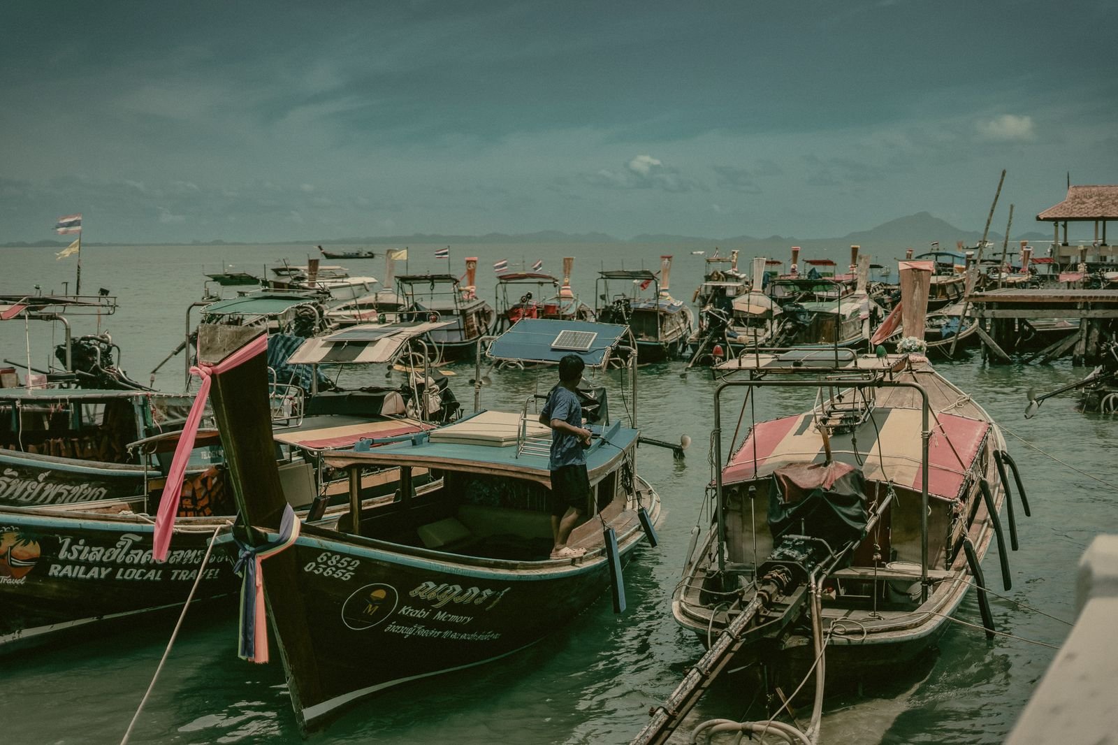Longtail boats moored at a pier in Krabi