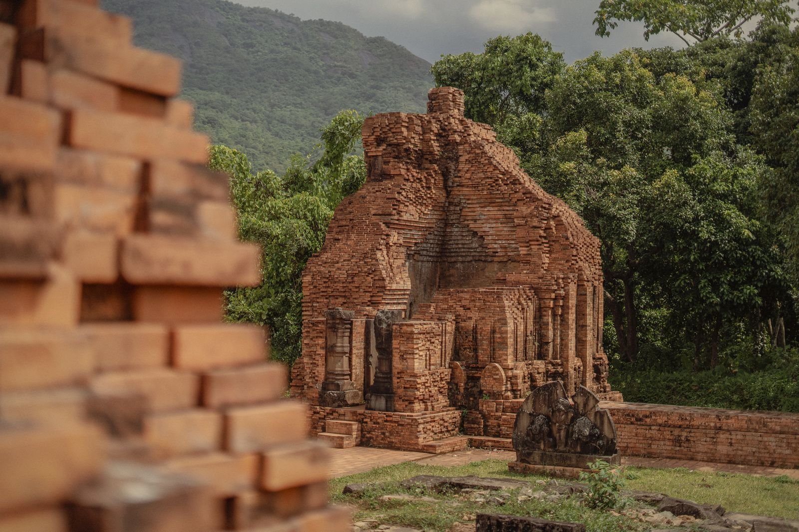 Brick ruins and fallen stones in the jungle at My Son Sanctuary