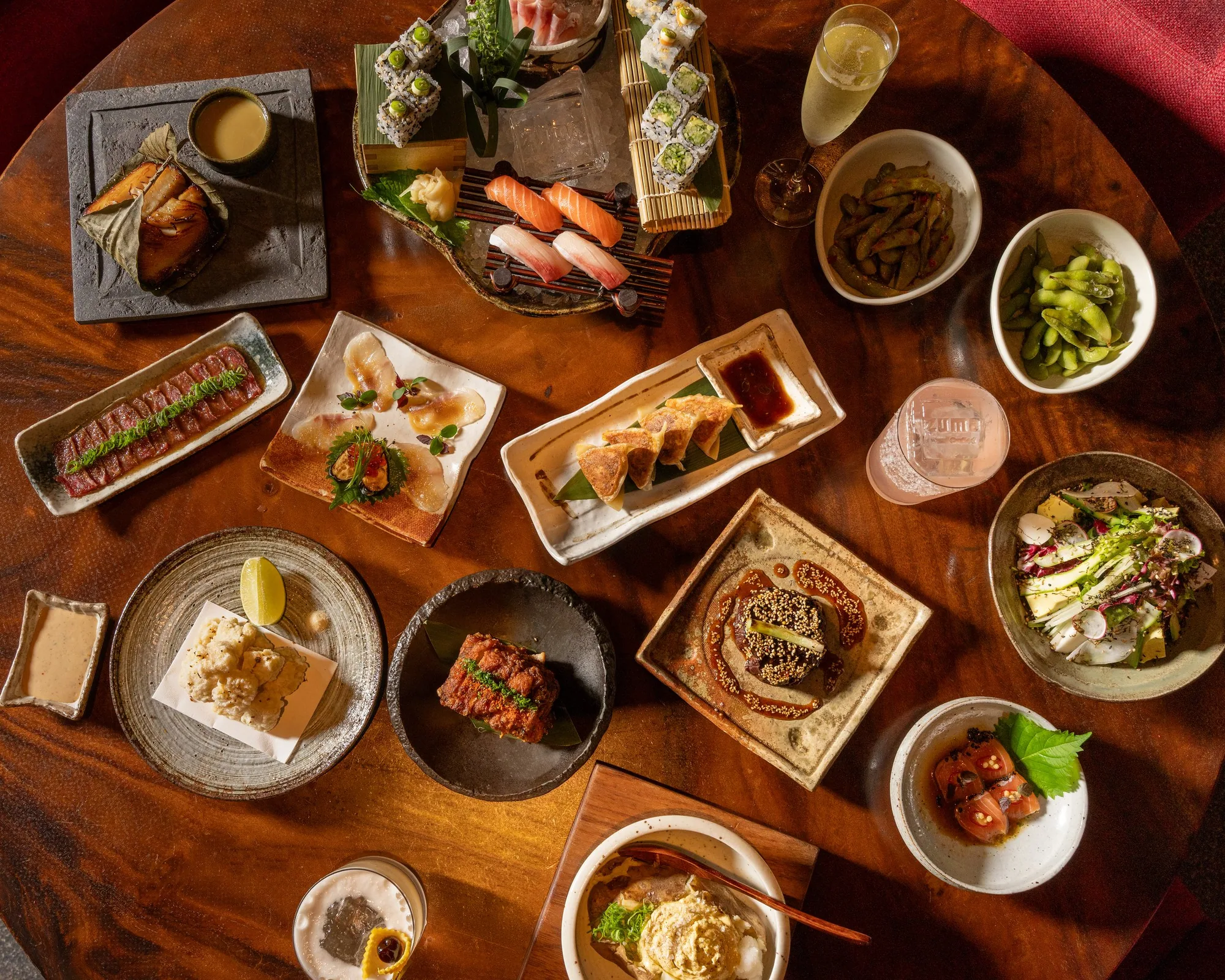 Overhead view of the Yashoku Night Brunch table at Zuma Doha with sushi, tataki and small plates